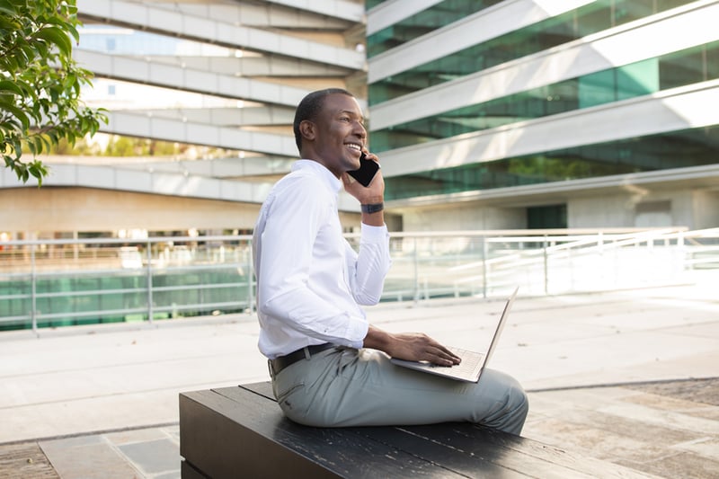 1-business-professional-engaged-phone-call-while-working-laptop