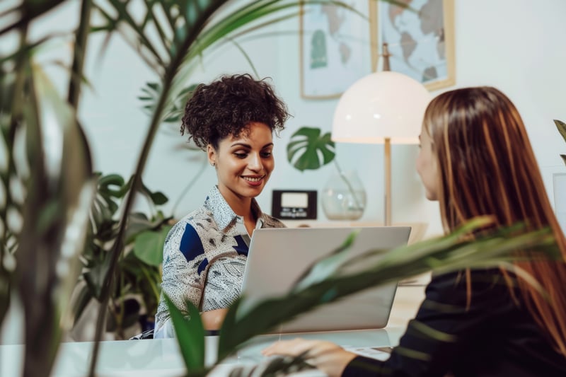 warm inviting professional meeting takes place lush plant filled office space suggesting collaboration productivity
