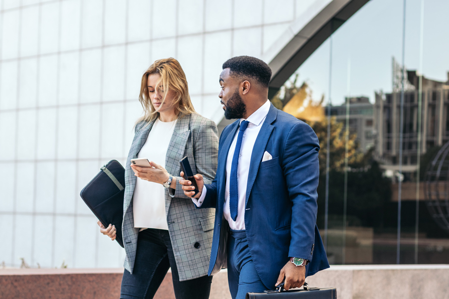 1-business-people-coworkers-talking-using-smartphone-outside-they-wear-suits-relax-break-outside-office