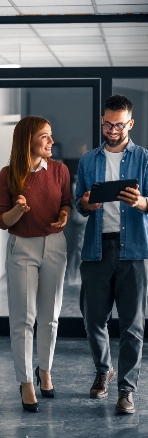 Colleagues discussing AI strategy with a tablet