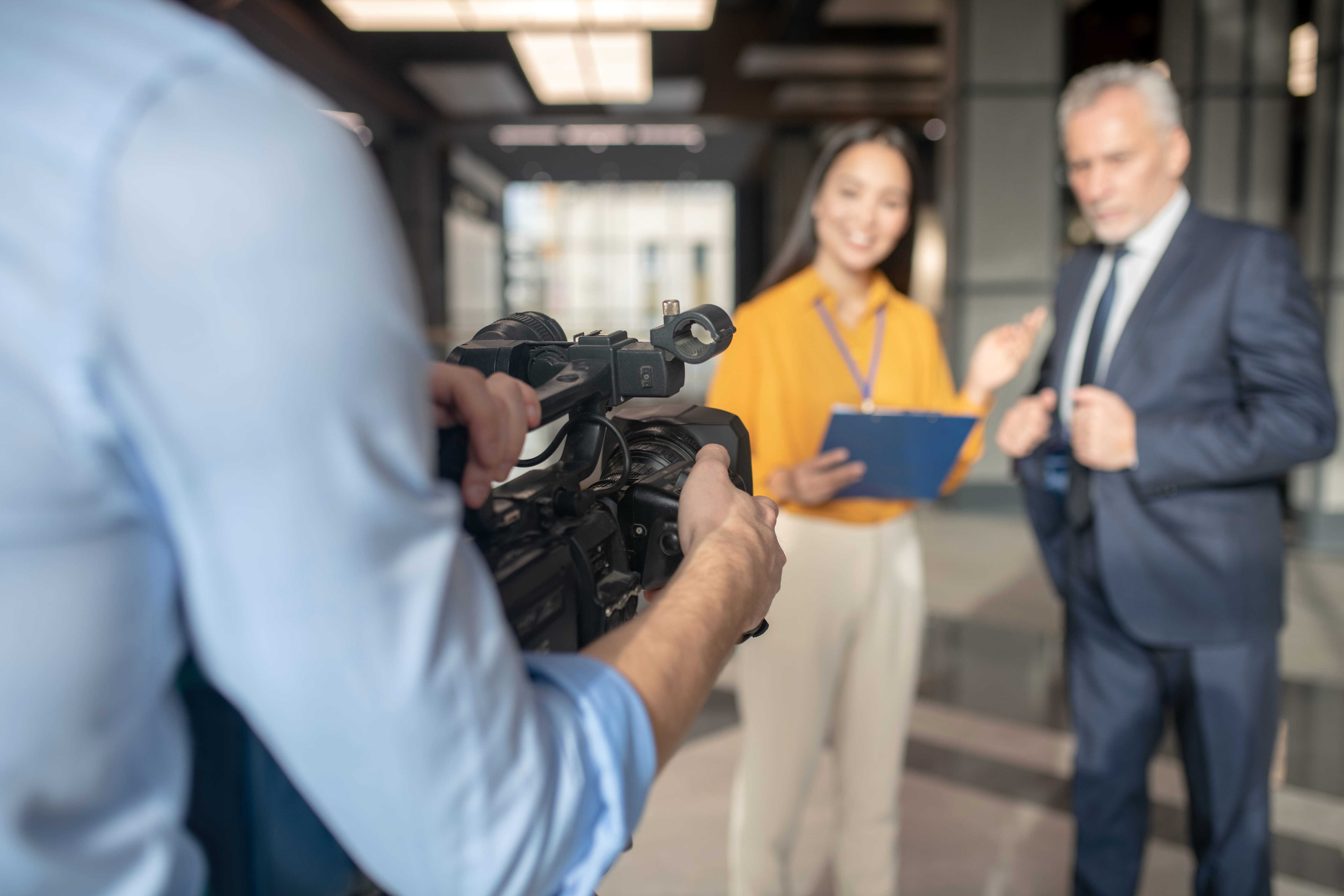 Coporate interview with a man holding a camera