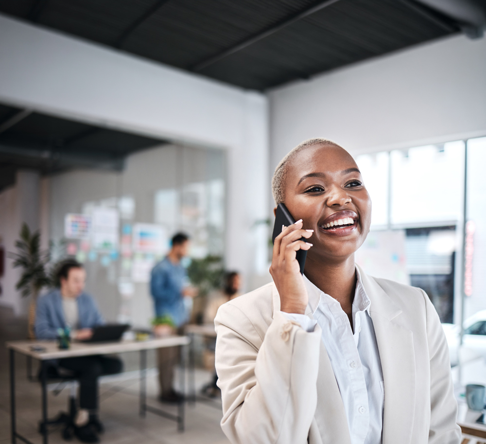 mobile-phone-call-funny-black-woman-office-communication-conversation-chat-smartphone-happy-african-business-professional-listen-laugh-discussion-with-contact-coworking-workplace