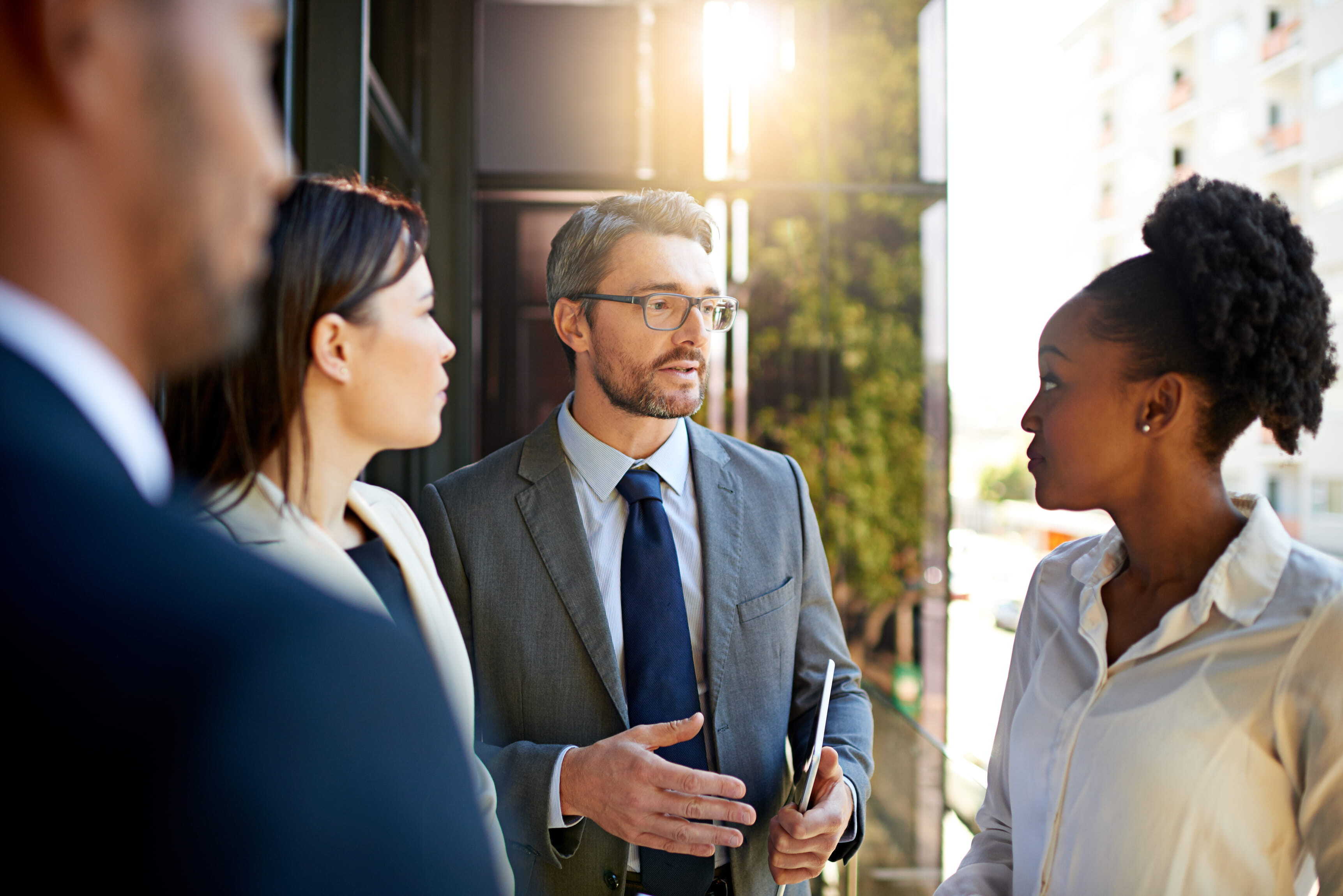 they-never-question-his-ideas-shot-diverse-group-businesspeople-having-meeting-balcony-bright-sunlight (1)